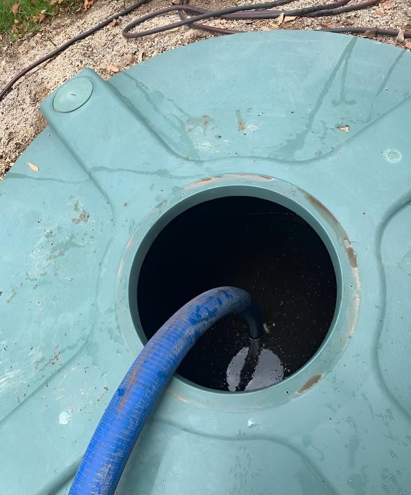 A Blue Hose is Connected to a Green Water Tank — Glenview Septic & Liquid Waste Removal In Beerwah, QLD