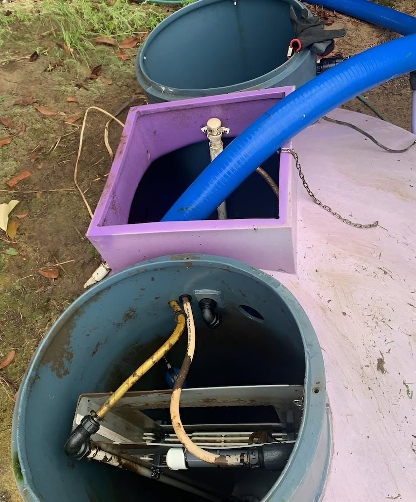 A Blue Hose is Coming Out of a Purple Box — Glenview Septic & Liquid Waste Removal In Narangba, QLD