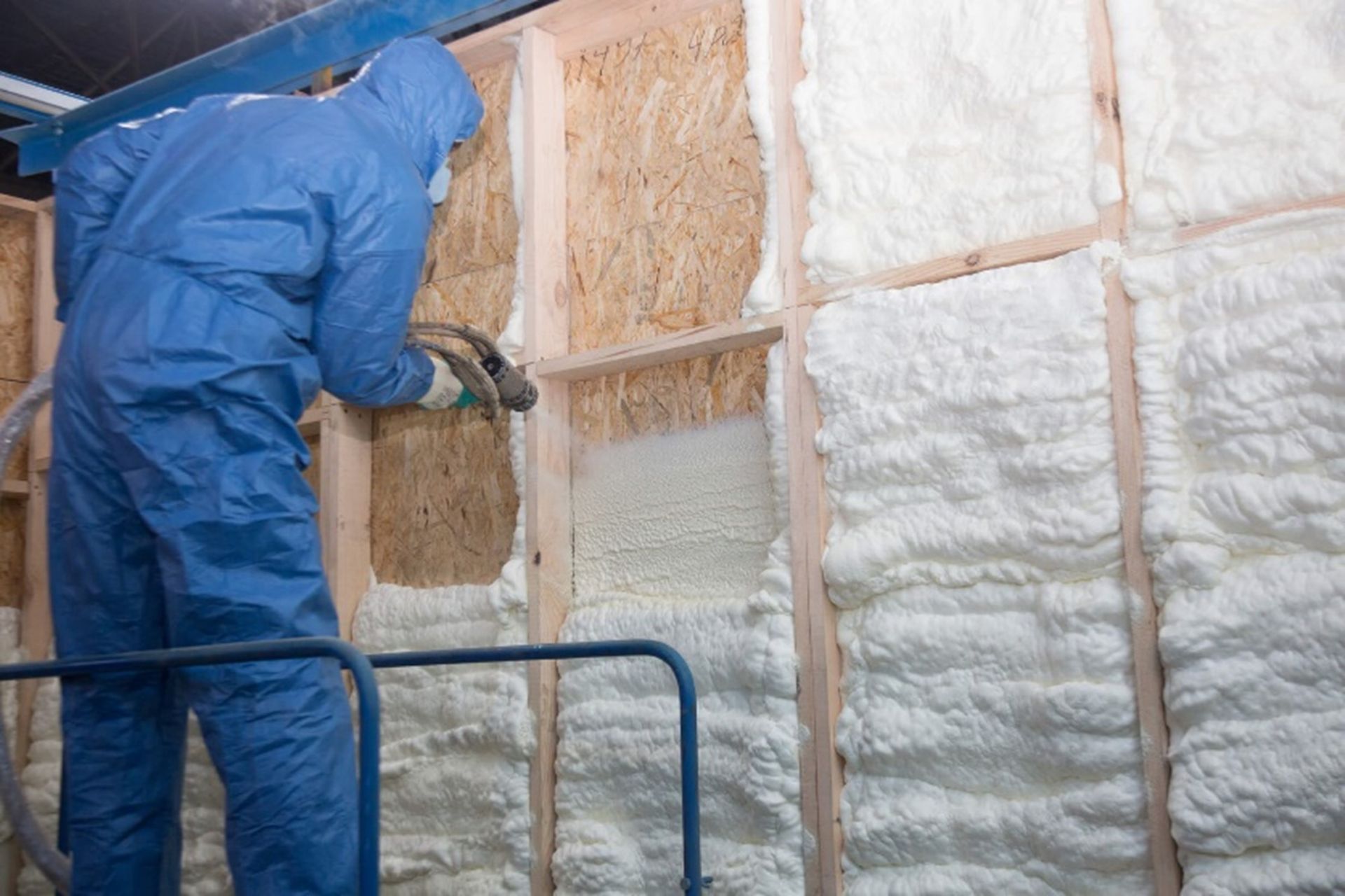 Worker sprays foam insulation in Chicago home