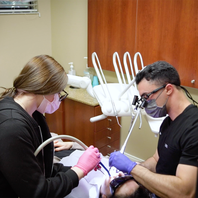 new patient laying in dental chair smiling