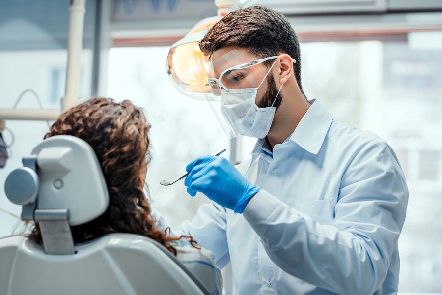 Dentist Checking Patients Teeth — Eastpointe, MI — Eastland & Professional Dental Center