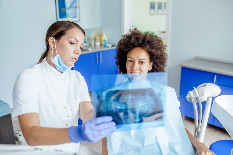 Dentist Showing Xray Result — Eastpointe, MI — Eastland & Professional Dental Center