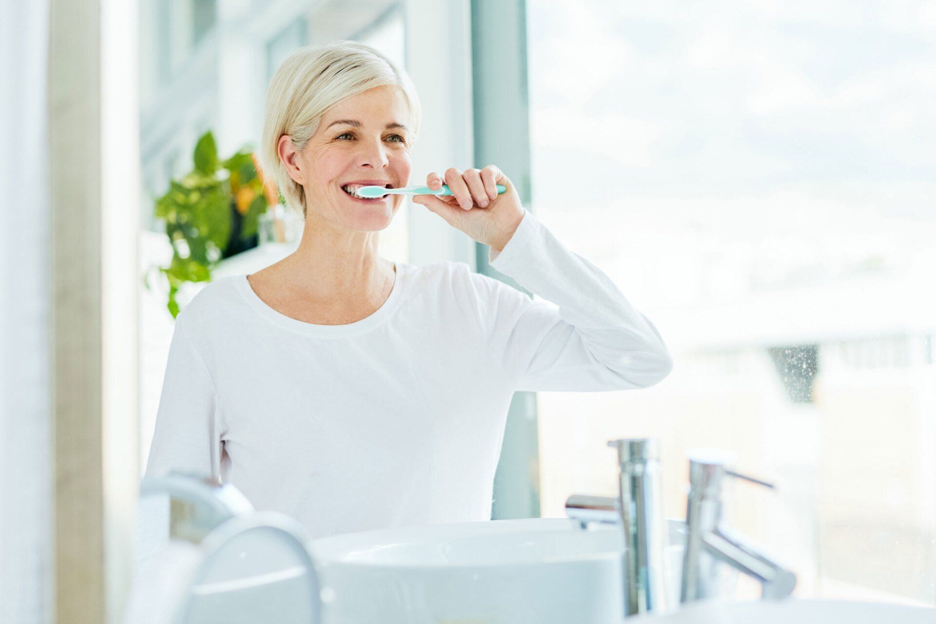 Woman Brushing Her Teeth — Eastpointe, MI — Universal Dental Center