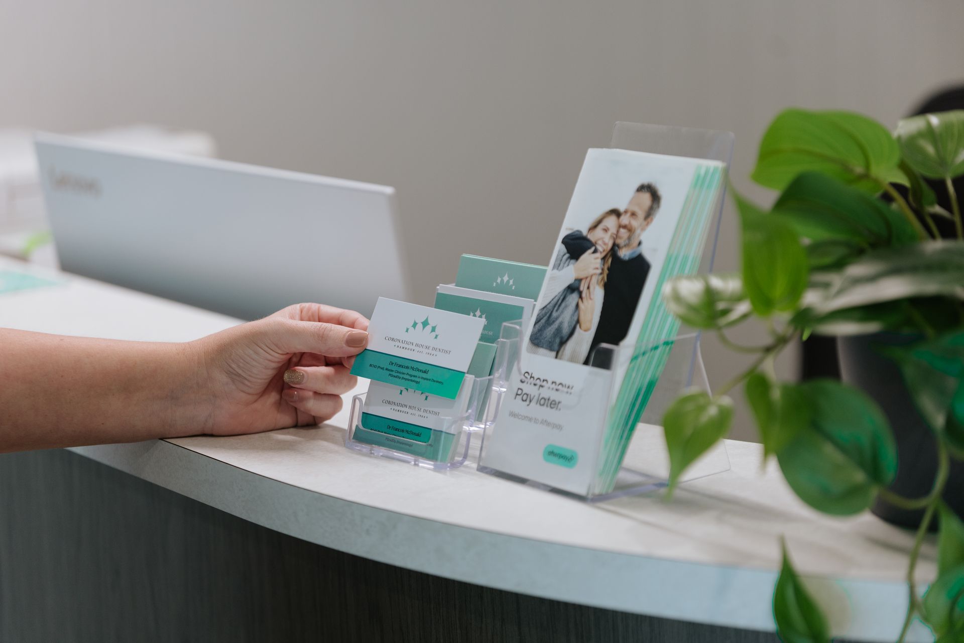 A Vase Filled With Flowers is Sitting on a Table Next to a Sign That Says the Park — Coronation House Dentist in Nambour, QLD