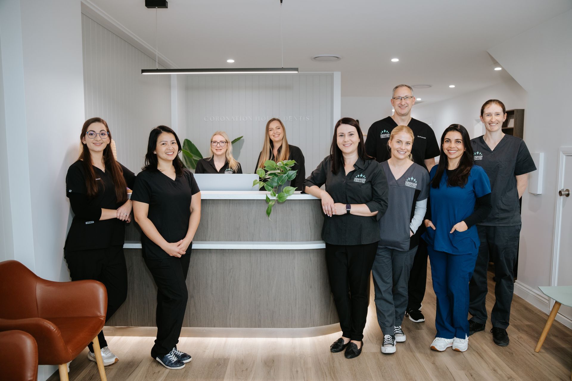 A Group of Nurses Are Posing for a Picture With a Cake — Coronation House Dentist in Nambour, QLD