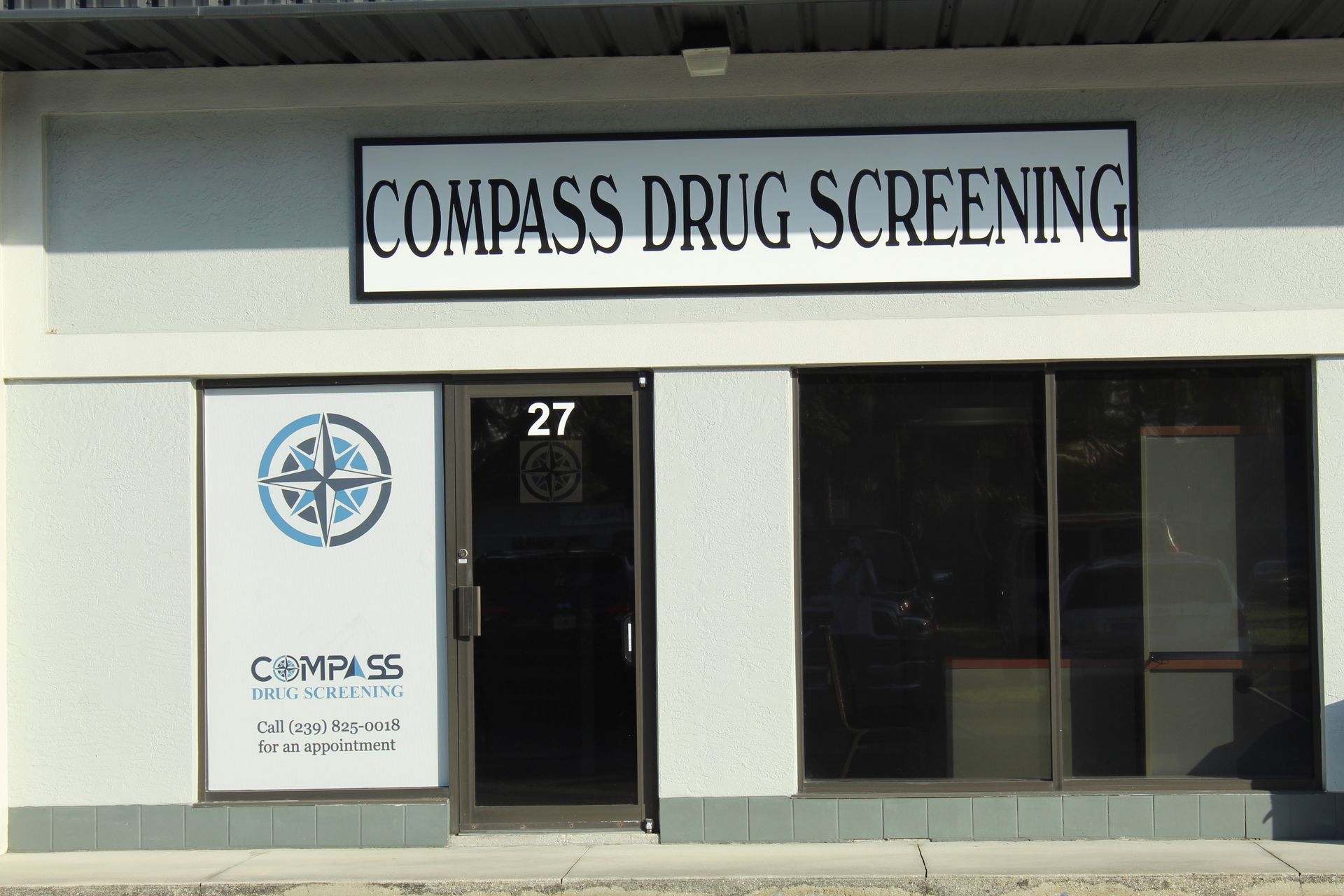A car is parked in front of compass drug screening