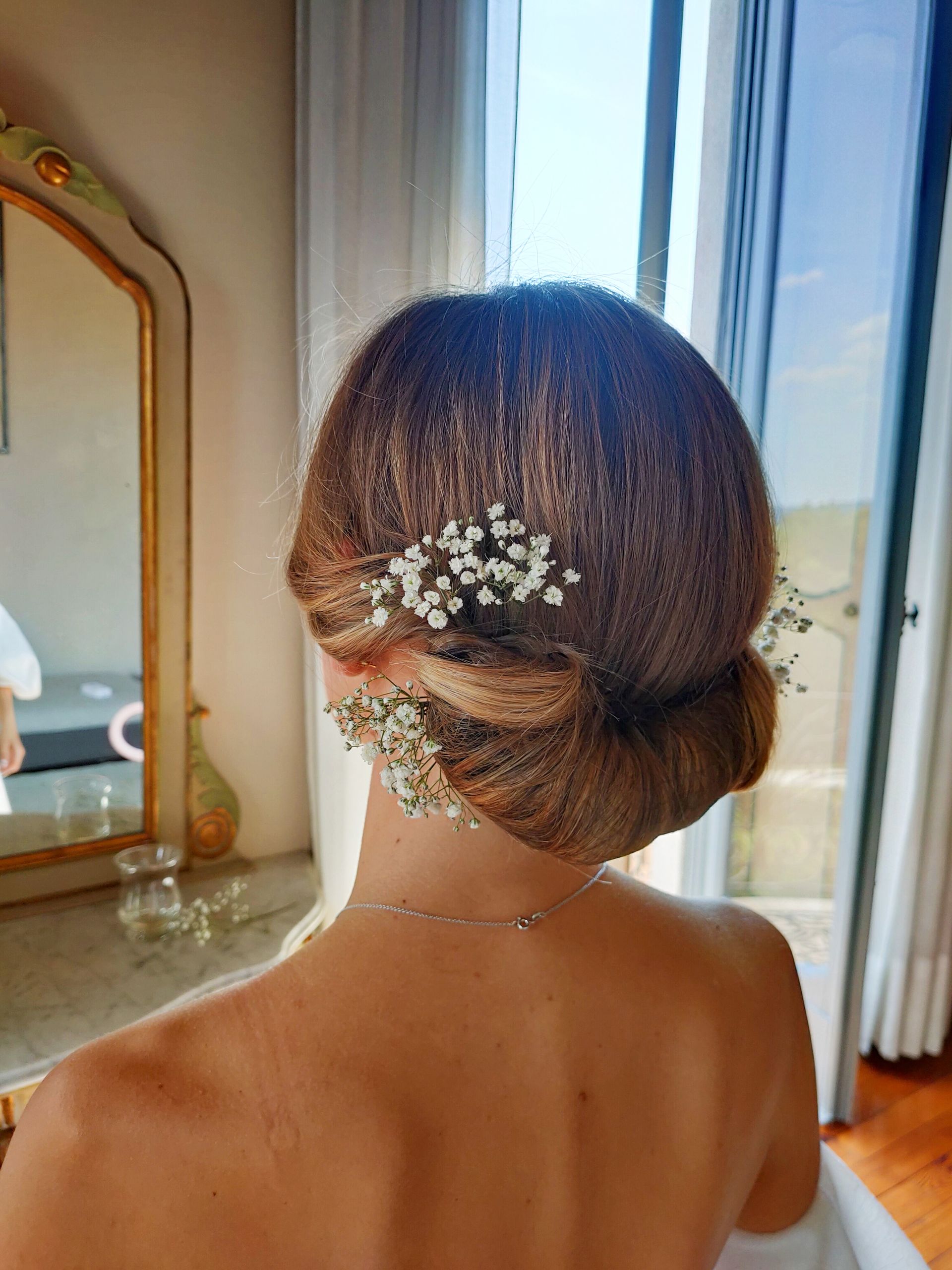 Una donna porta uno chignon con il respiro del bambino tra i capelli.