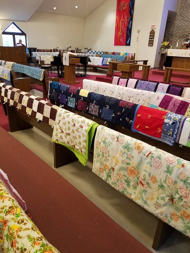 Congregation members eating a meal around a table with others.