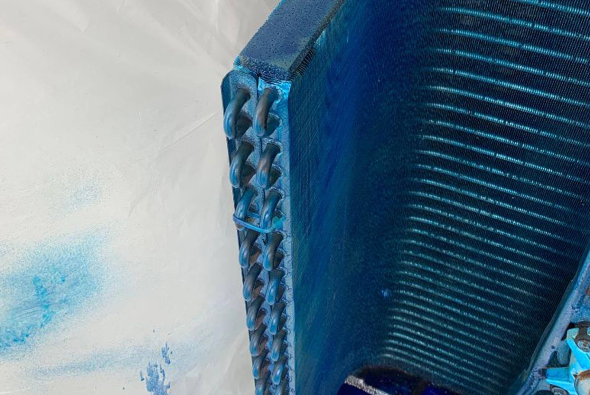 A close up of a blue object on a white surface