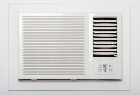 A white air conditioner is mounted on a white wall.