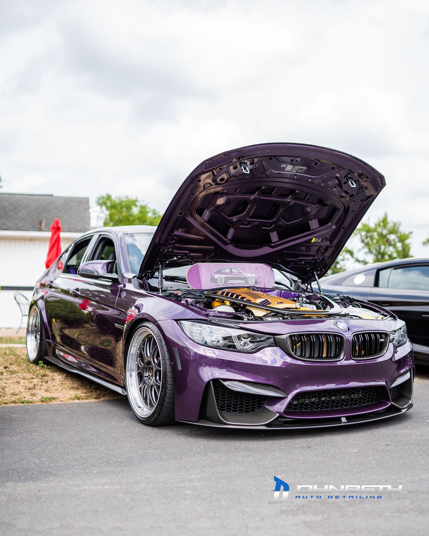 purple car with open hood