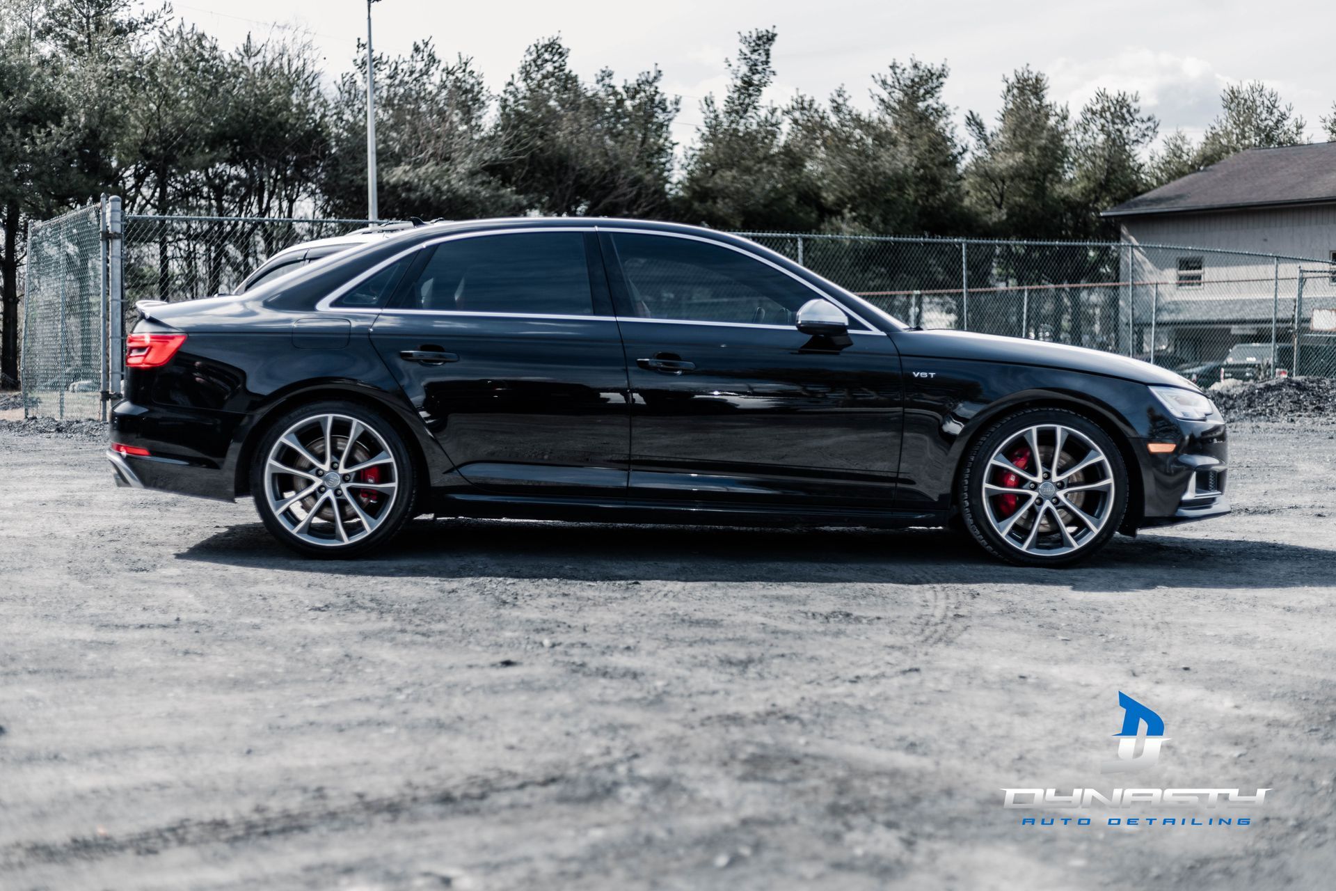 A black audi a4 is parked in a parking lot.
