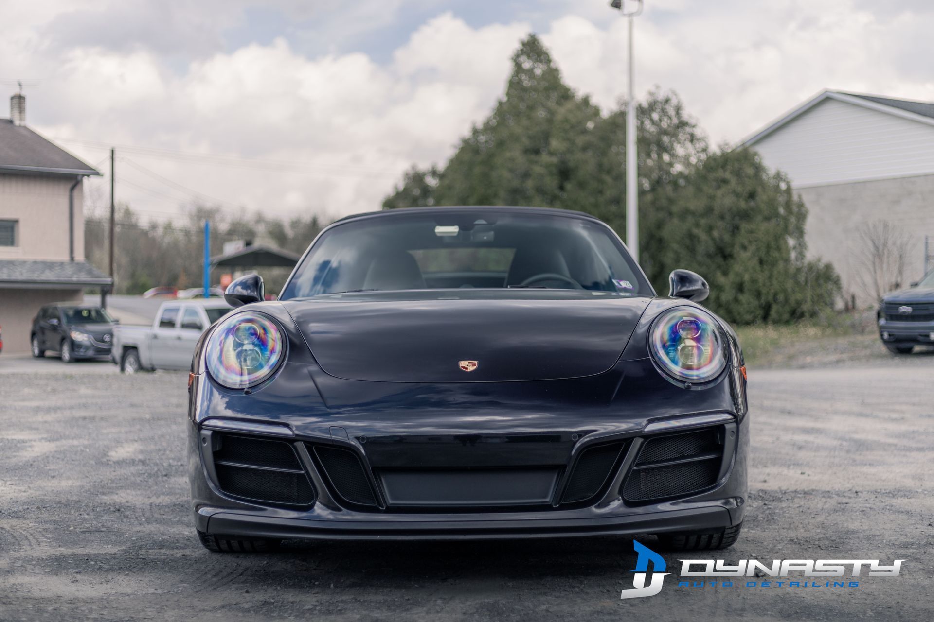 A black porsche 911 gt3 is parked in a parking lot.