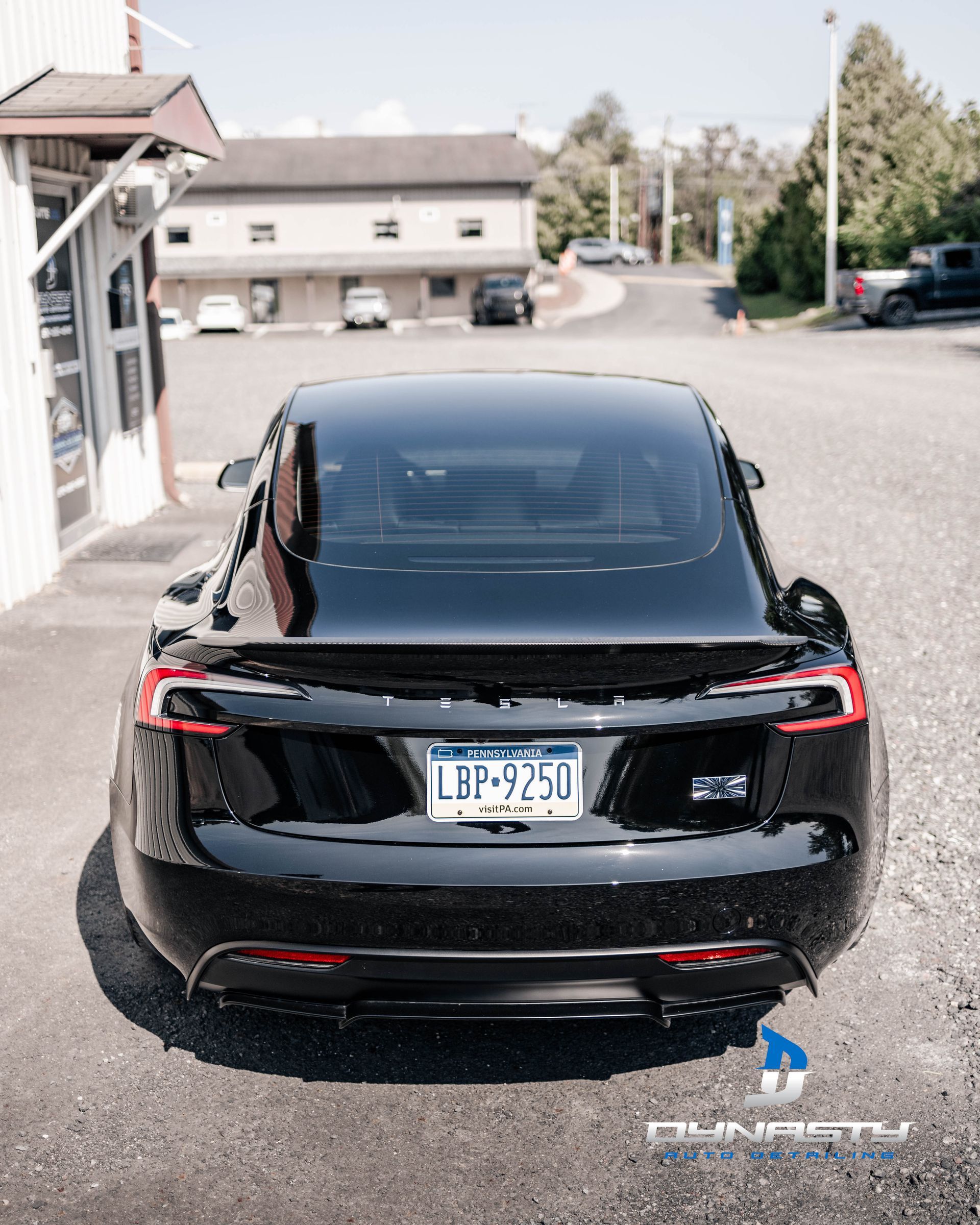 A black tesla model s is parked in a parking lot
