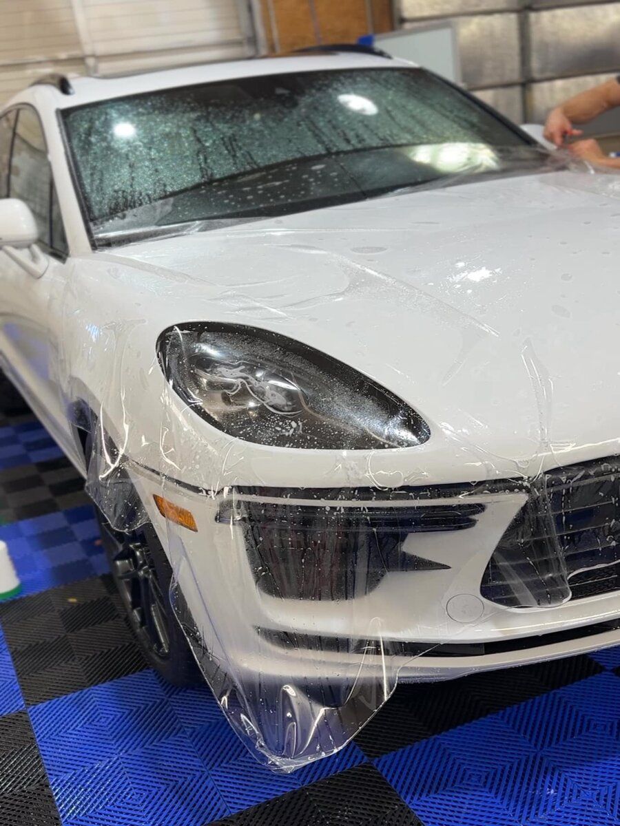 Paint Protection Film - A white Porsche Macan turbo is wrapped in plastic.