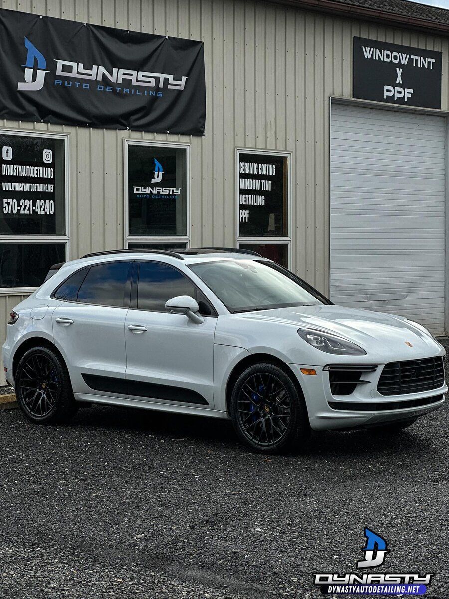 Paint Protection Film - A white Porsche Macan turbo is parked in front of a building.