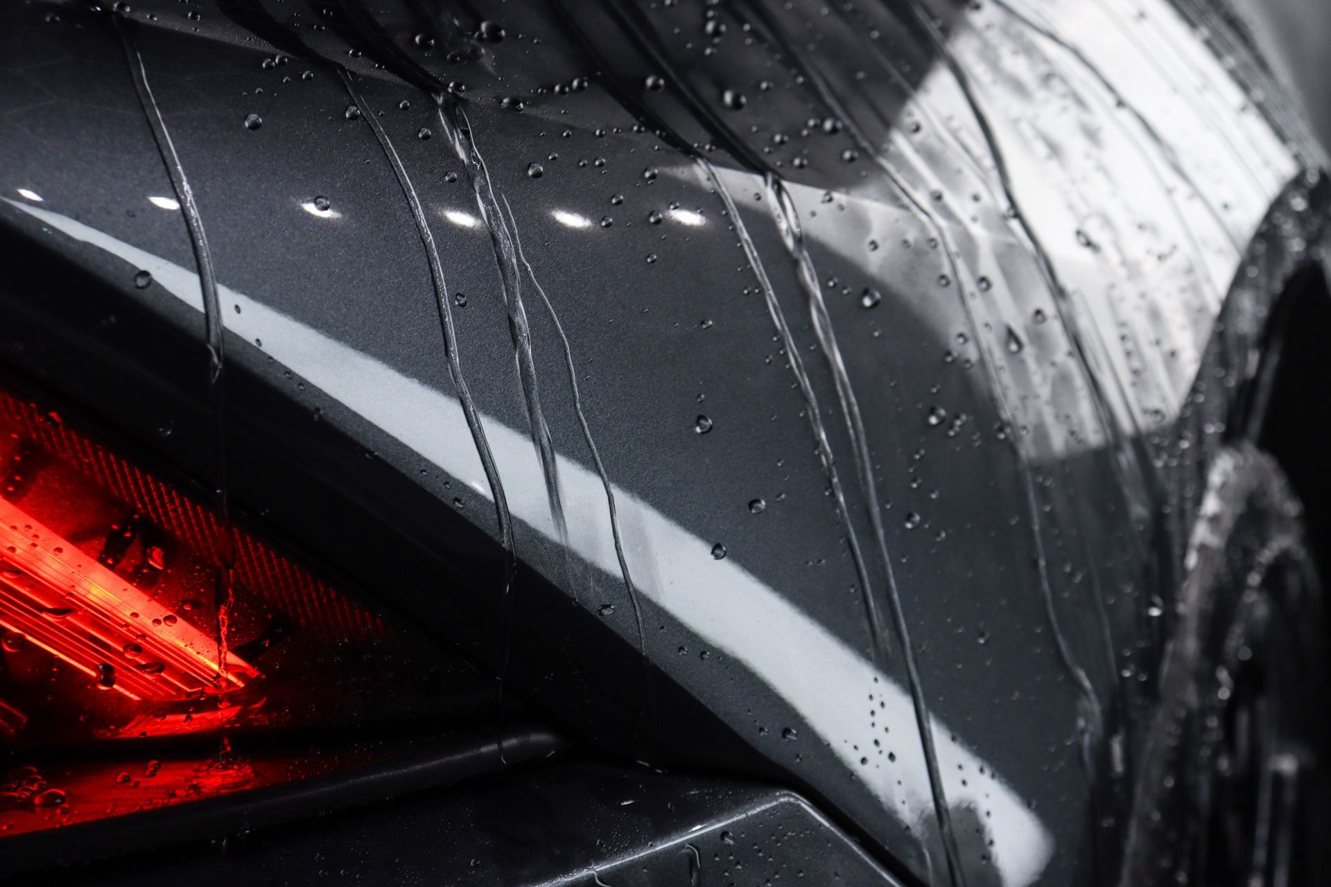 A close up of a car with water drops on it.