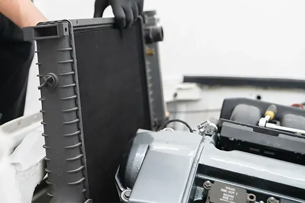 Close-up of a black camera battery compartment with a gray mechanical component beside it
