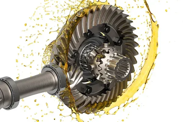 Close-up of a metal gear assembly with yellow grease splashing around it