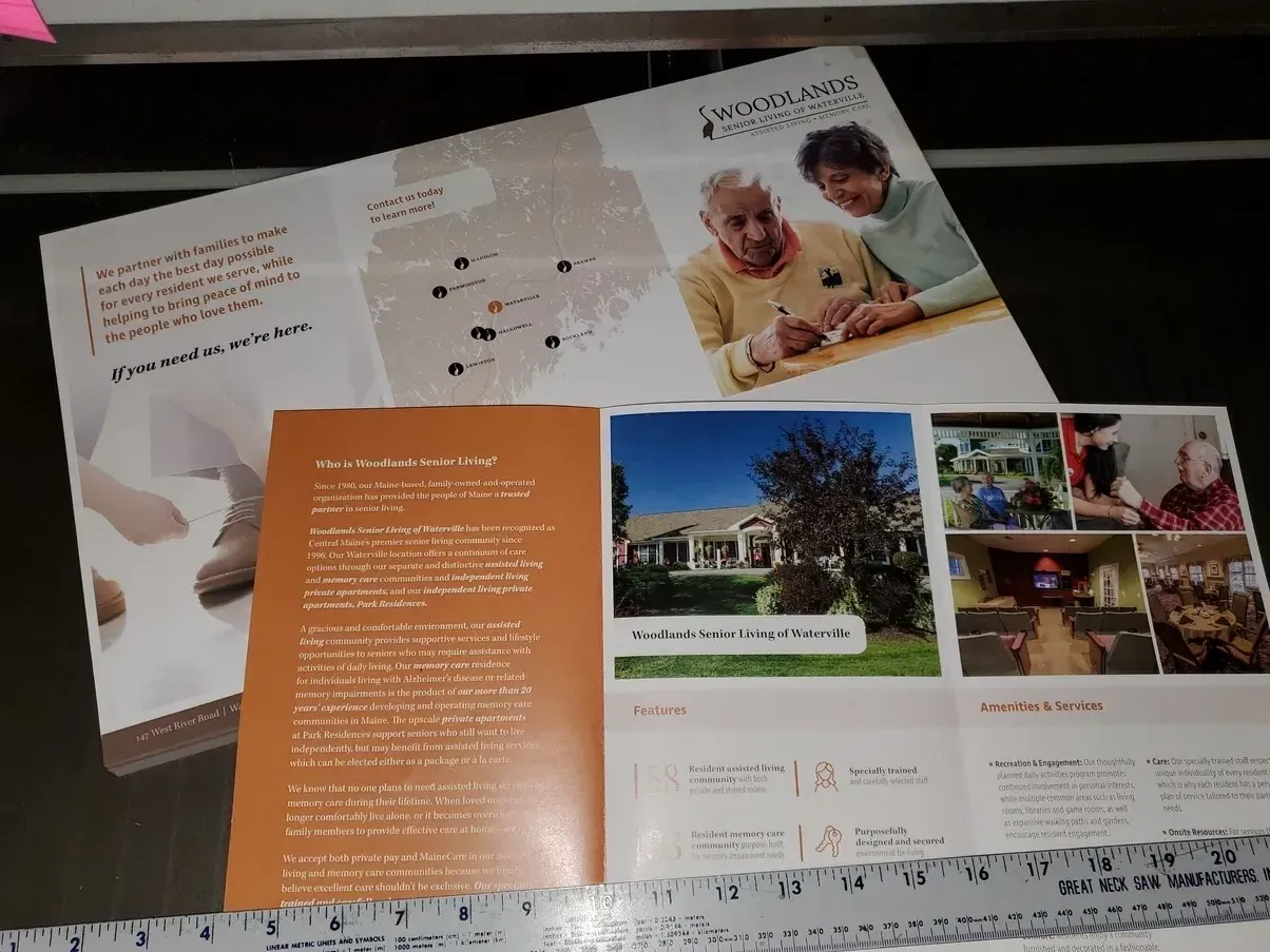 Brochure promoting senior living; elderly couple, facility exterior, interior photos; orange and white color scheme.