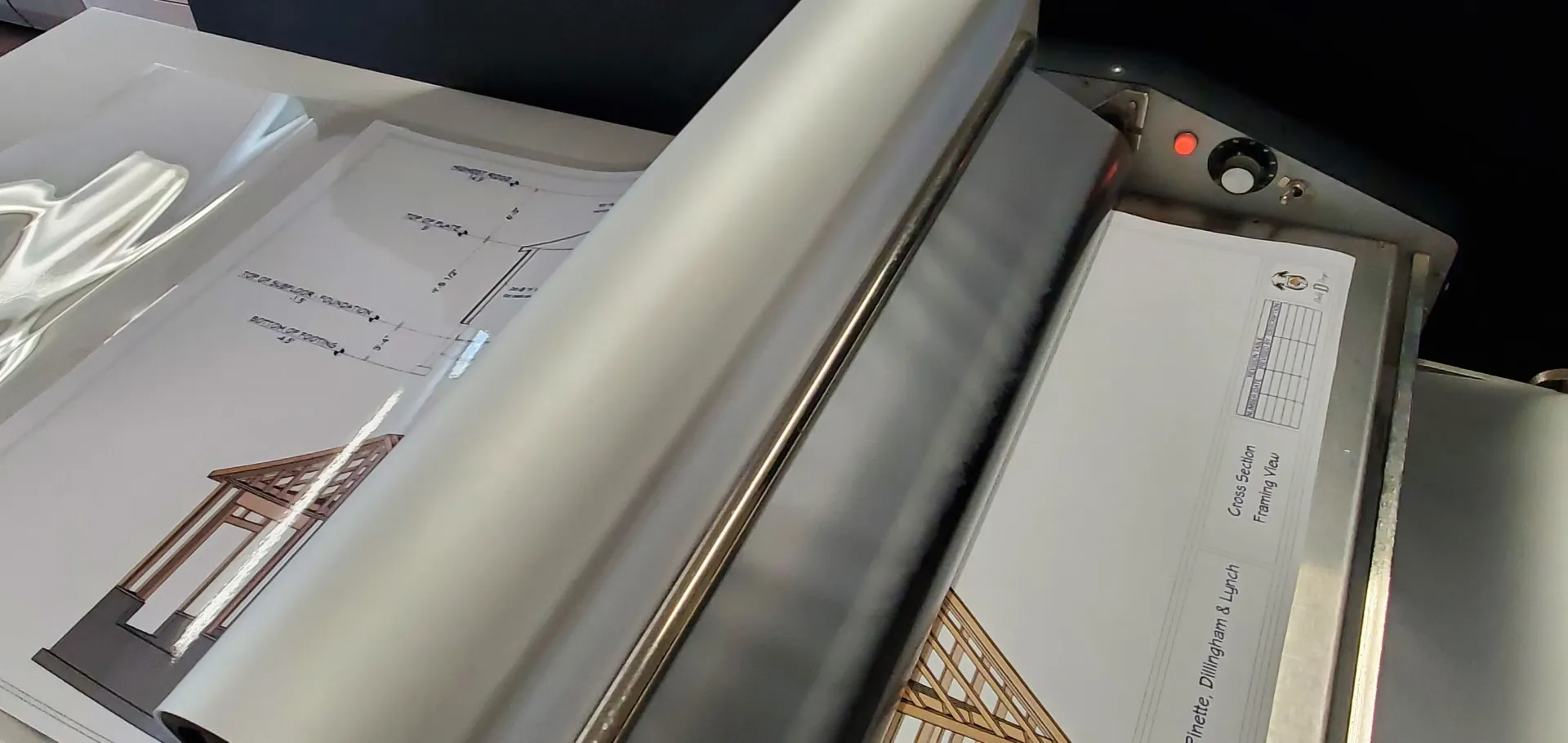 Documents being laminated on a machine.
