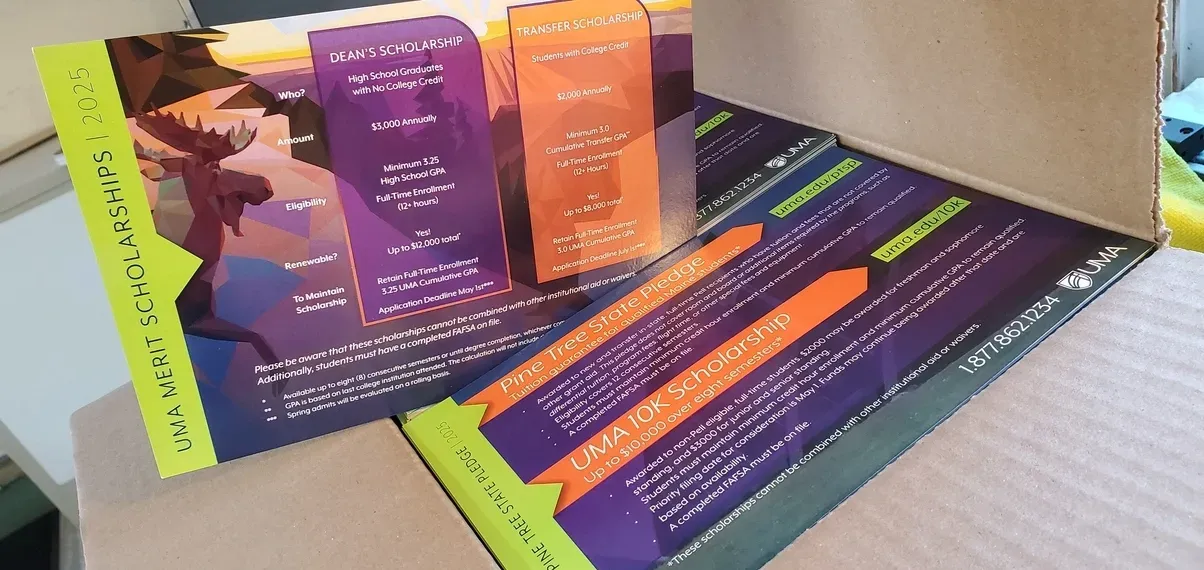 Open box holding colorful cards, purple and orange text on cards.