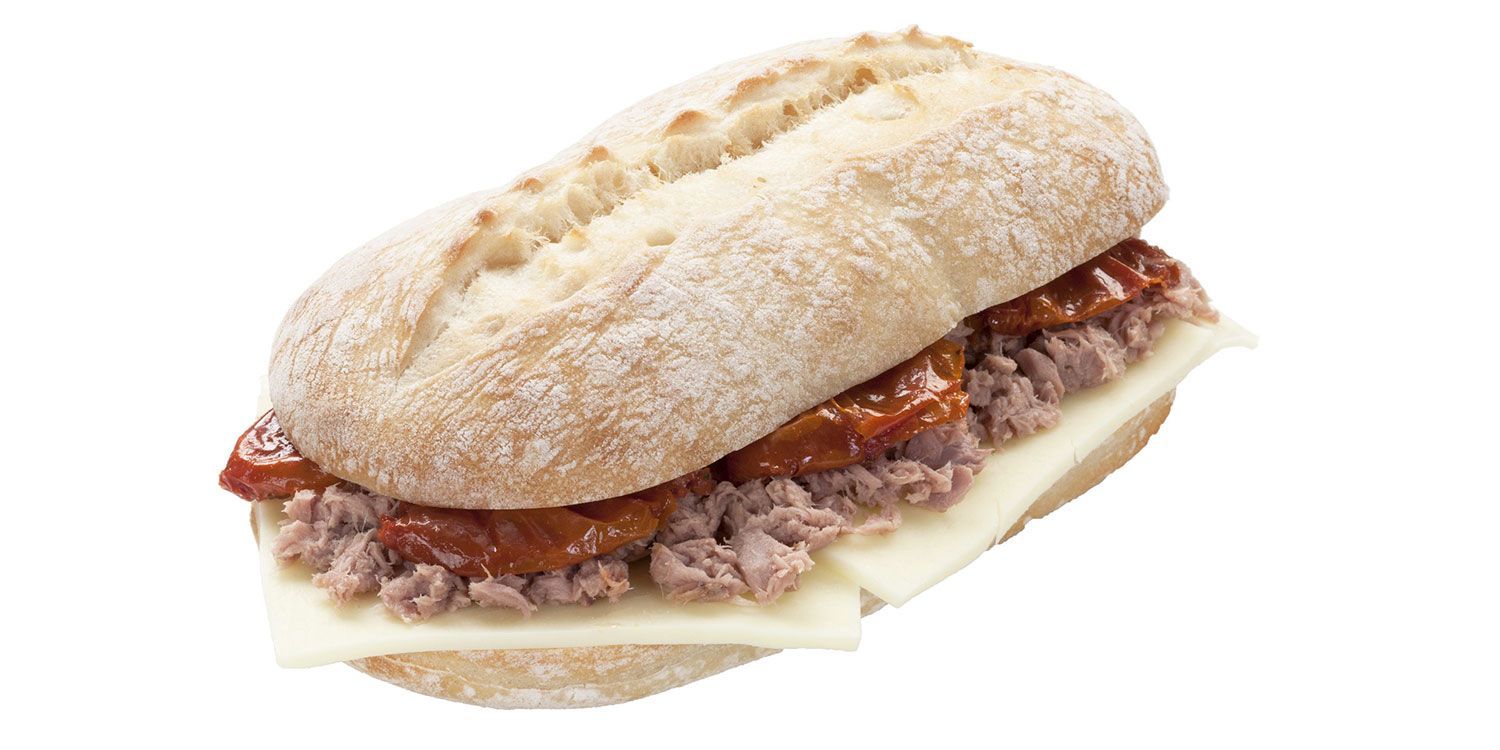 Un panino con tonno, formaggio e pomodori su uno sfondo bianco.