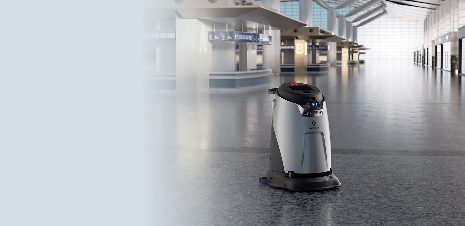 A robotic vacuum cleaner is cleaning the floor of an airport terminal.