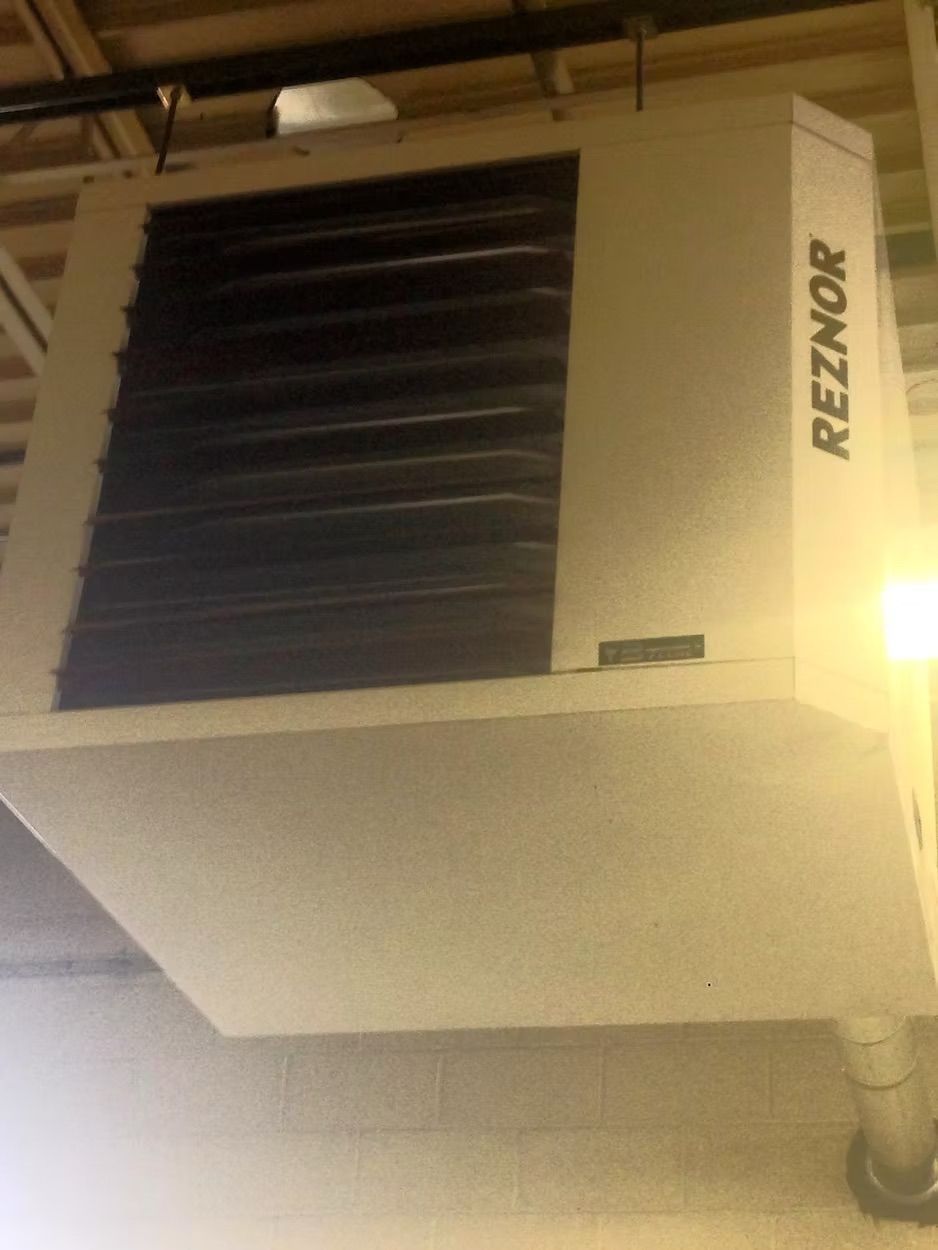 White Reznor industrial heater mounted on a ceiling.