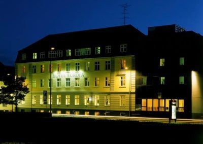 Hotel building at night, brightly lit with many windows.