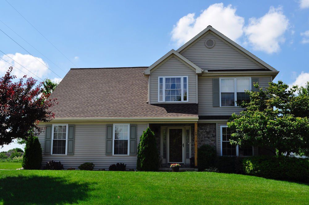 A large house with a lush green lawn in front of it