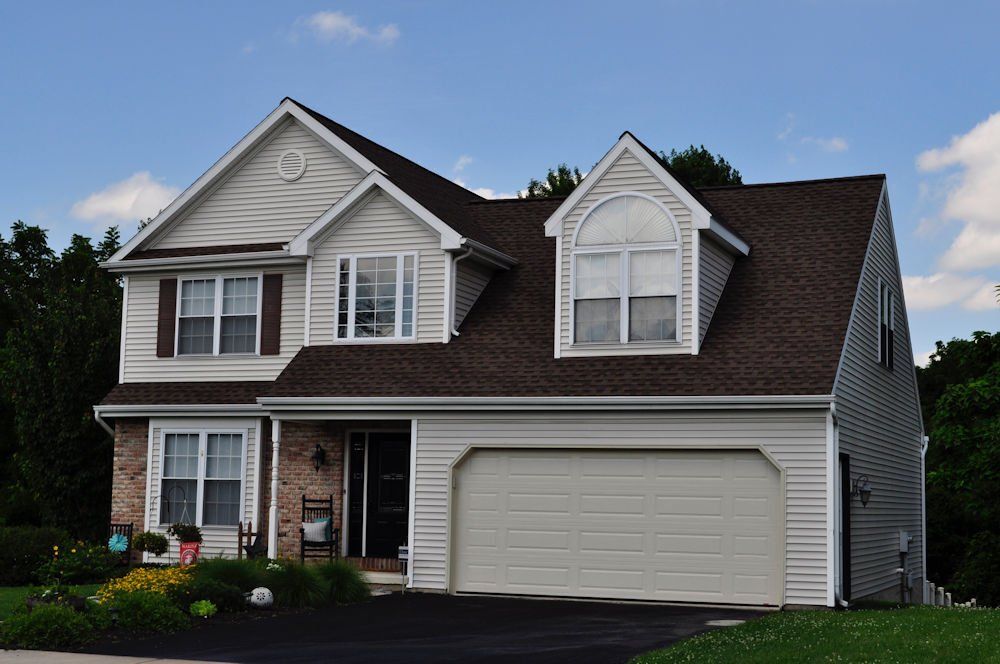 A large white house with a brown roof