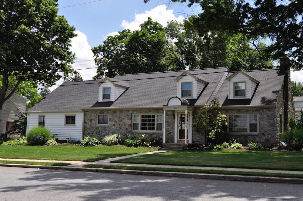 A house with a gray roof and white trim