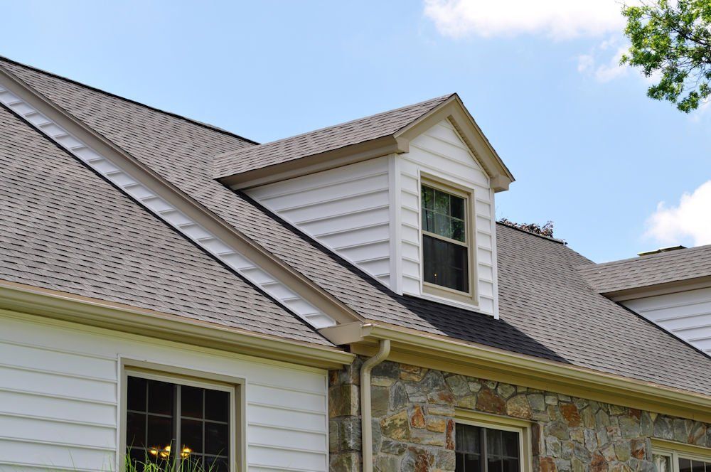 A house with a roof that has a window on it.