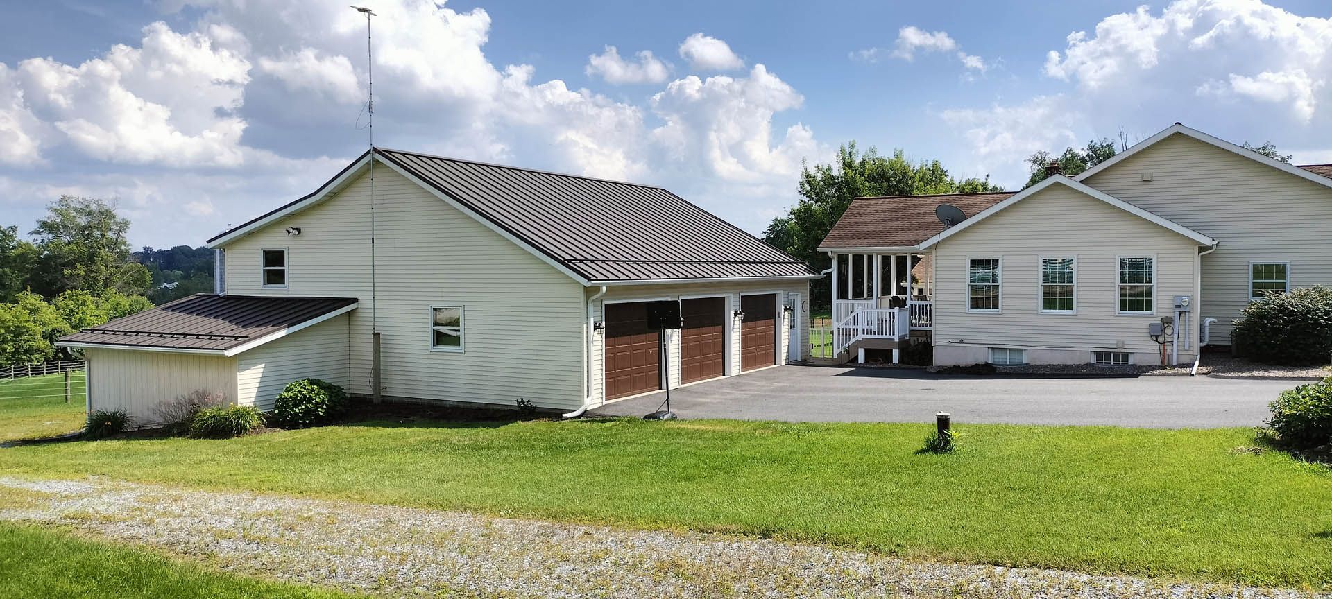 Garage with a new metal roof with brown garage doors