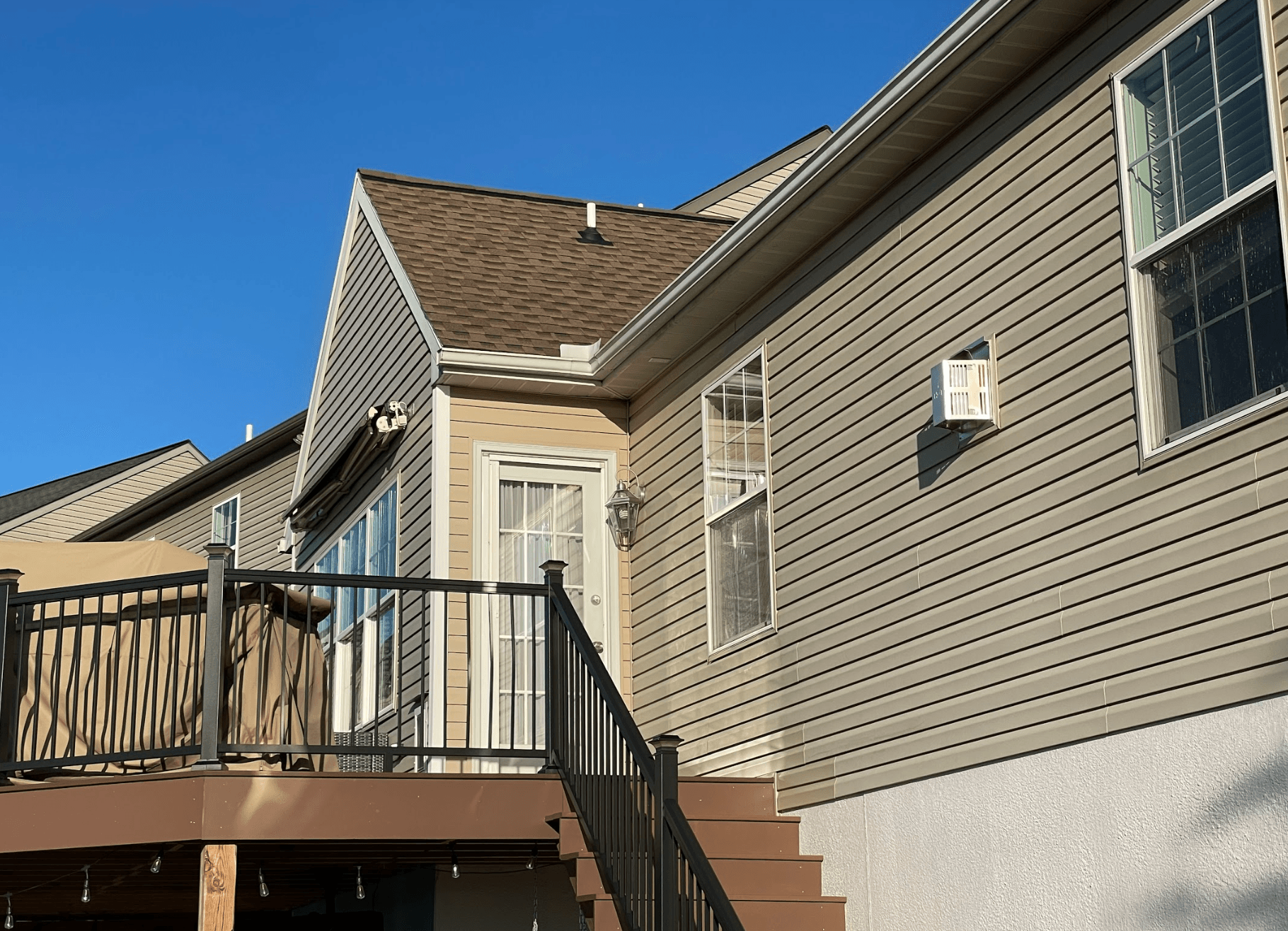 A house with a deck and stairs leading up to it