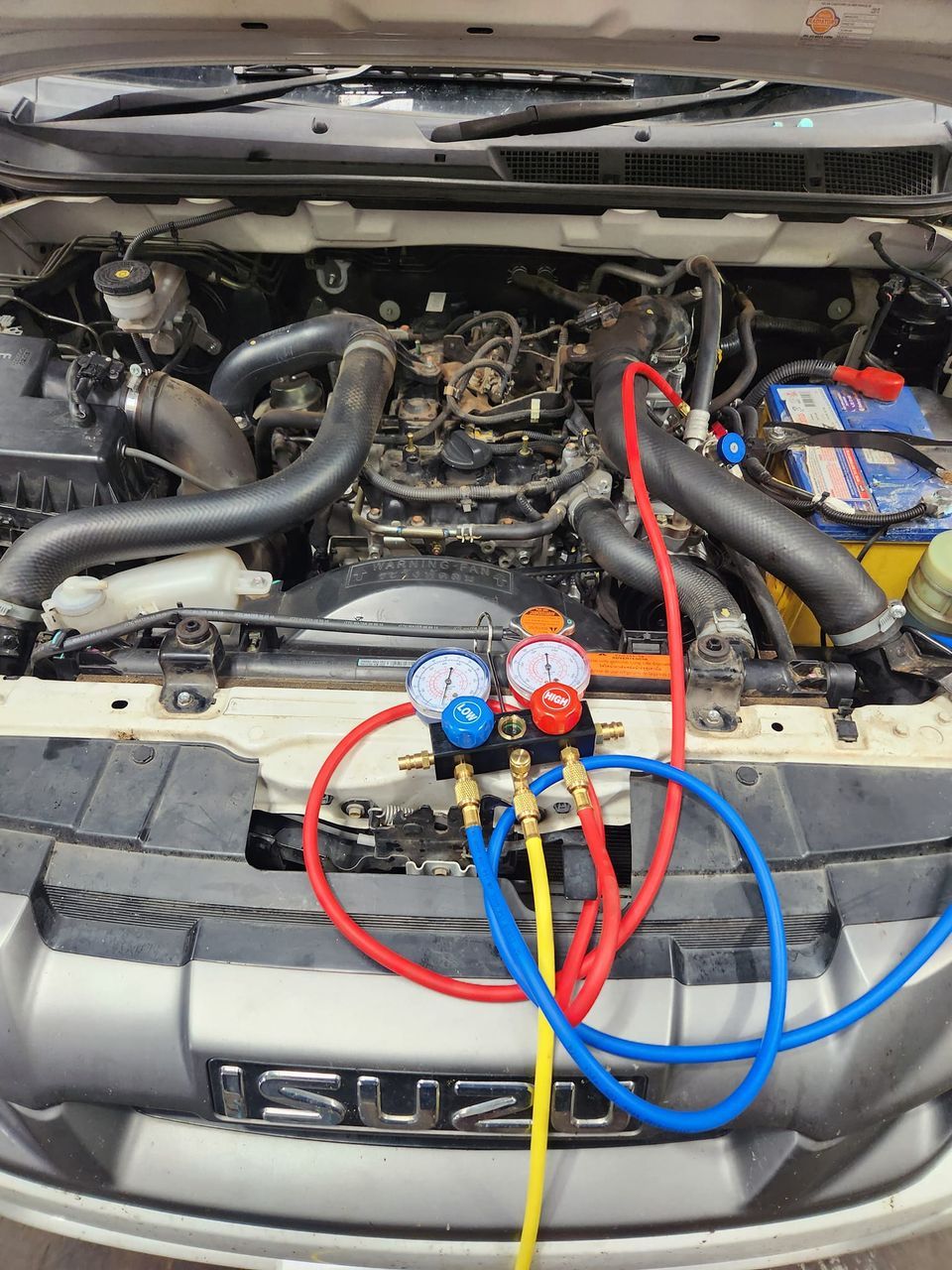 A White Truck with A Canopy on Top of It Is Parked in A Parking Lot — Genesis Automotive Services in Lavington, NSW