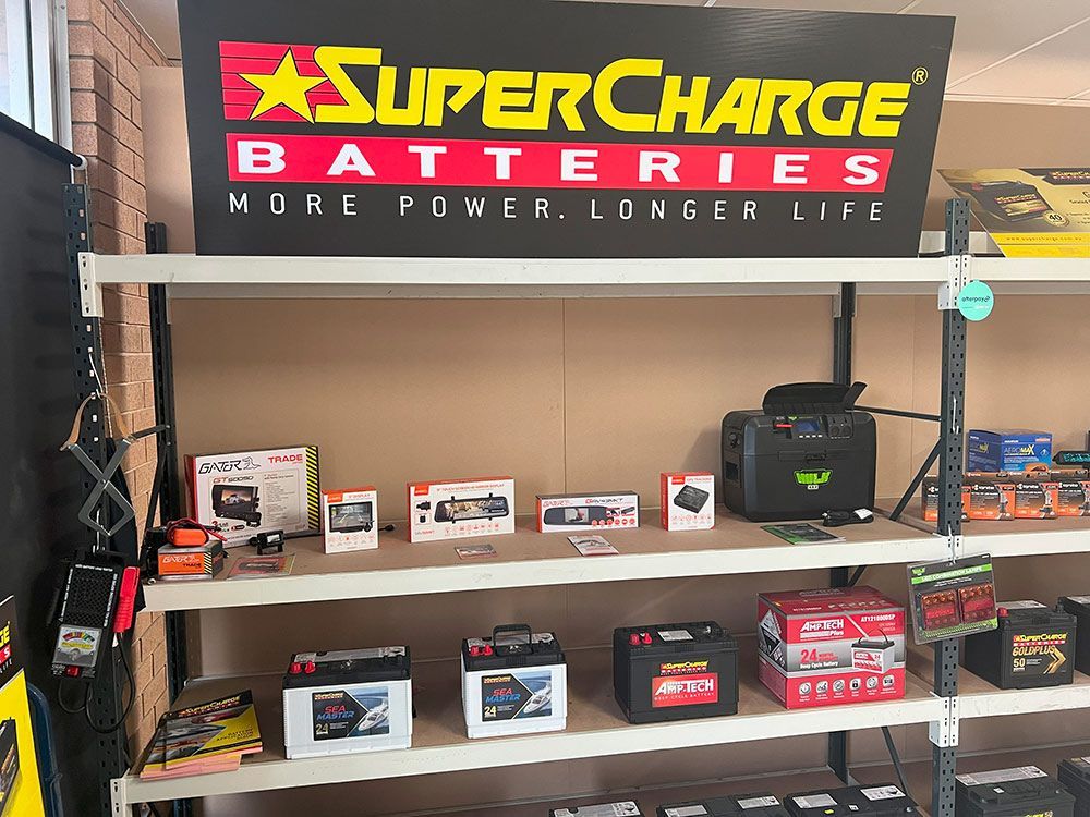 An Orange Car with The Hood Open Is Parked in A Garage — Genesis Automotive Services in Lavington, NSW