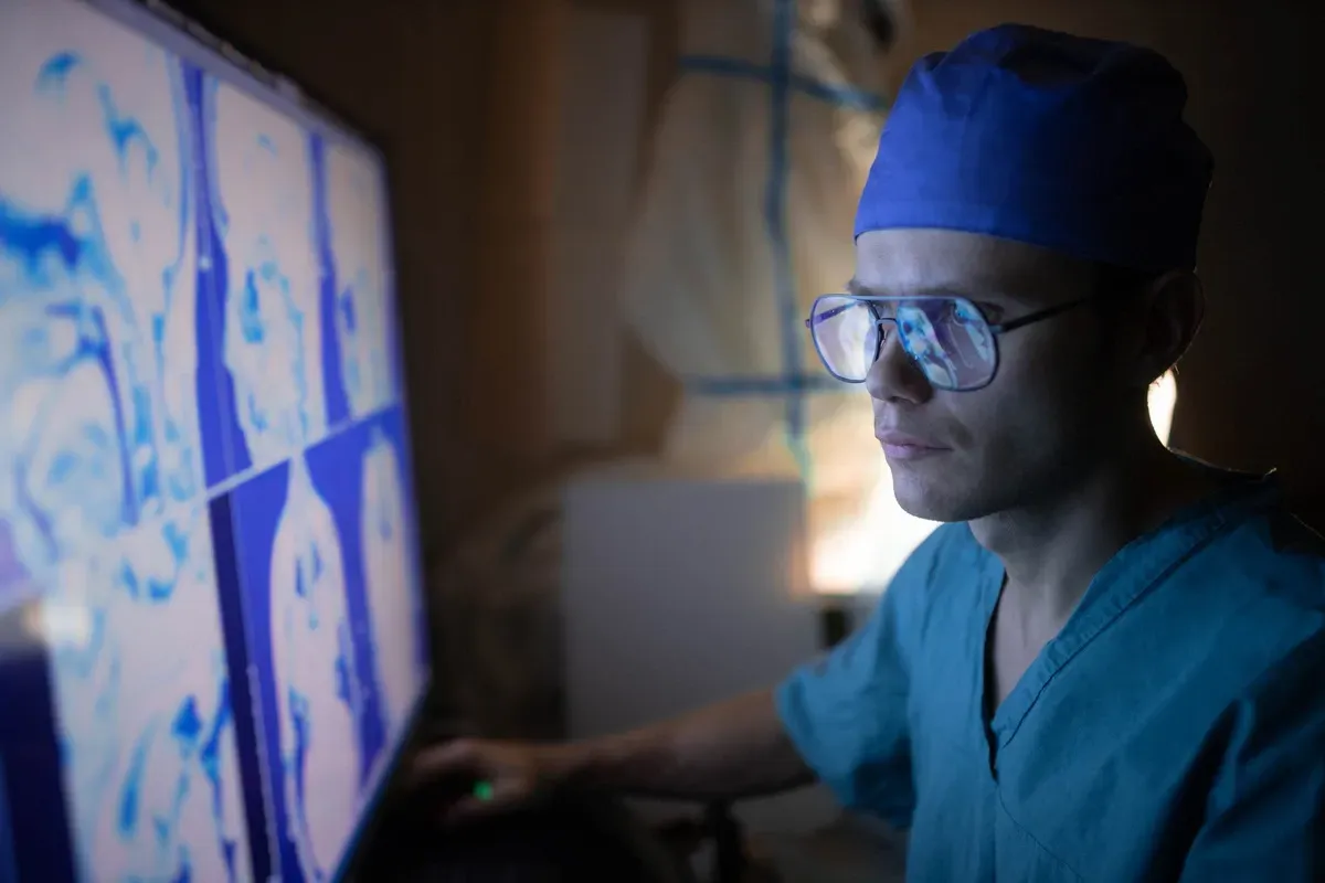 doctor looks at ultrasound monitor