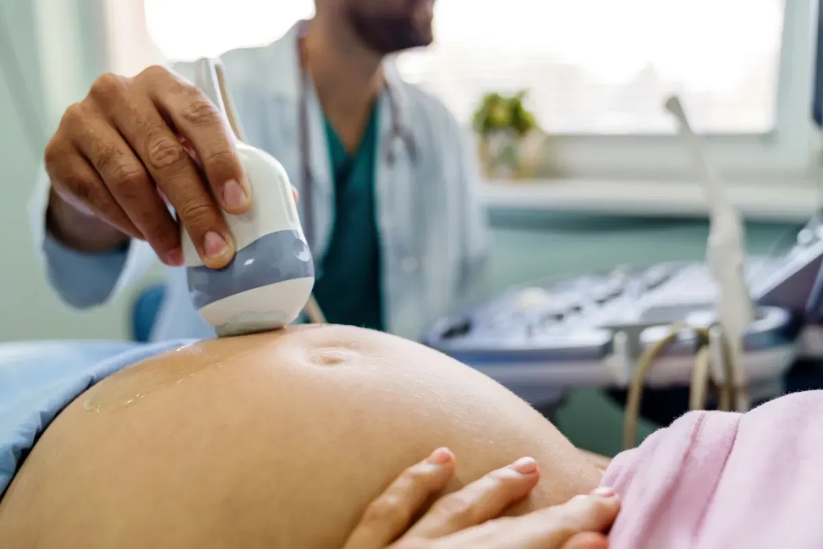doctor using ultrasound device on pregnant patient