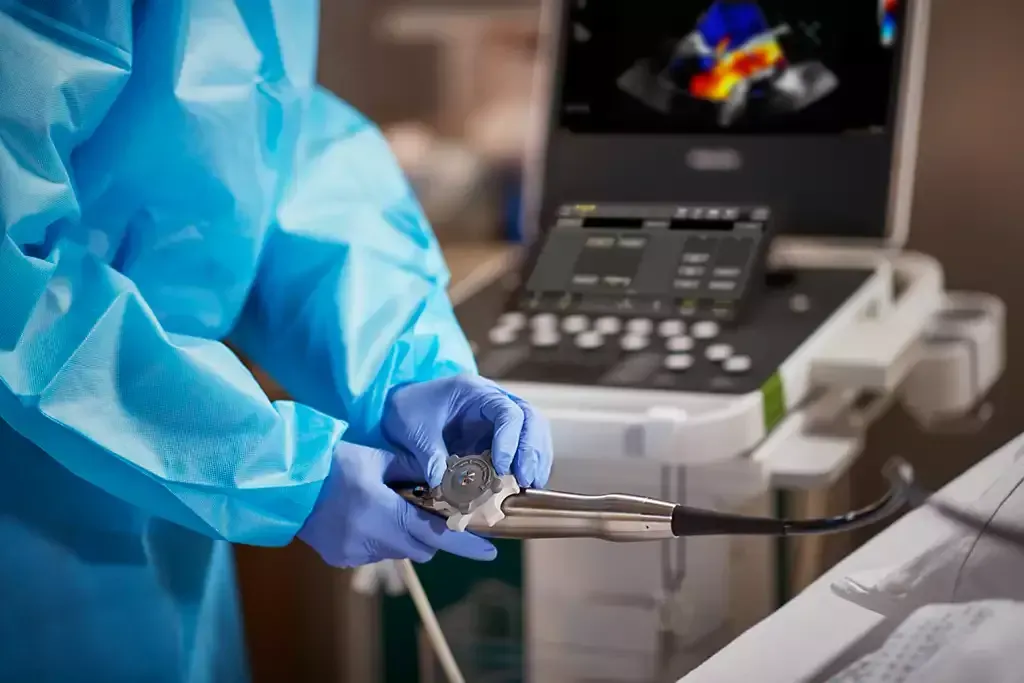 doctor in scrubs holding an ultrasound wand