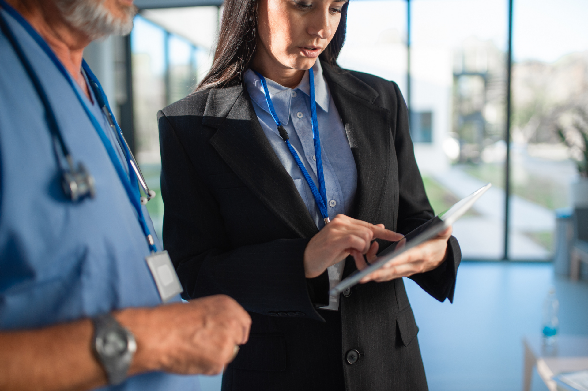 woman with tablet explaining something to a doctor