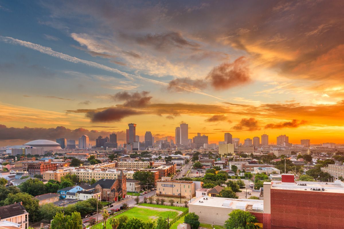 City skyline with sunset in background.