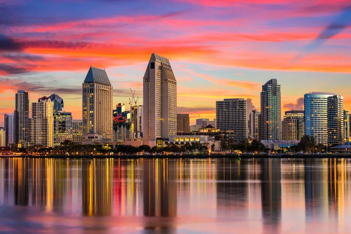 tall buildings skyline by a body of water