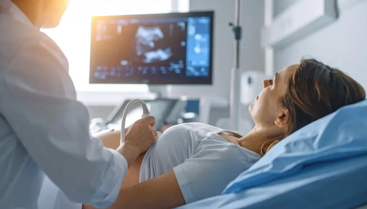 pregnant woman receiving ultrasound test from medical professional