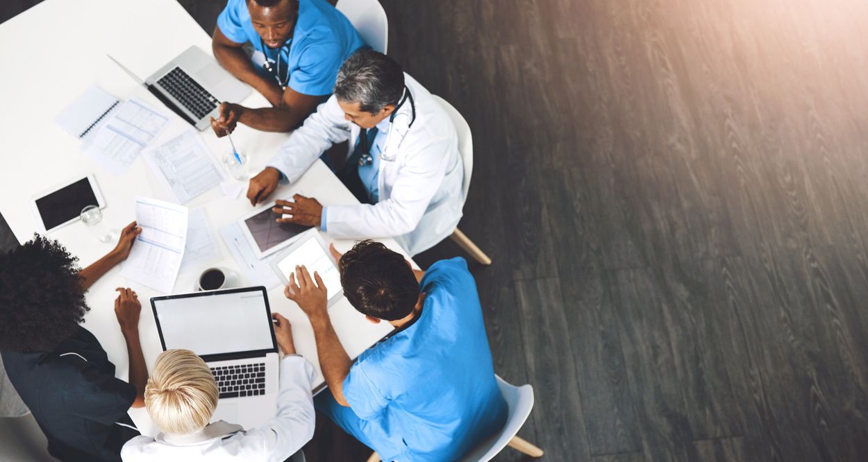 medical staff sitting at table 
