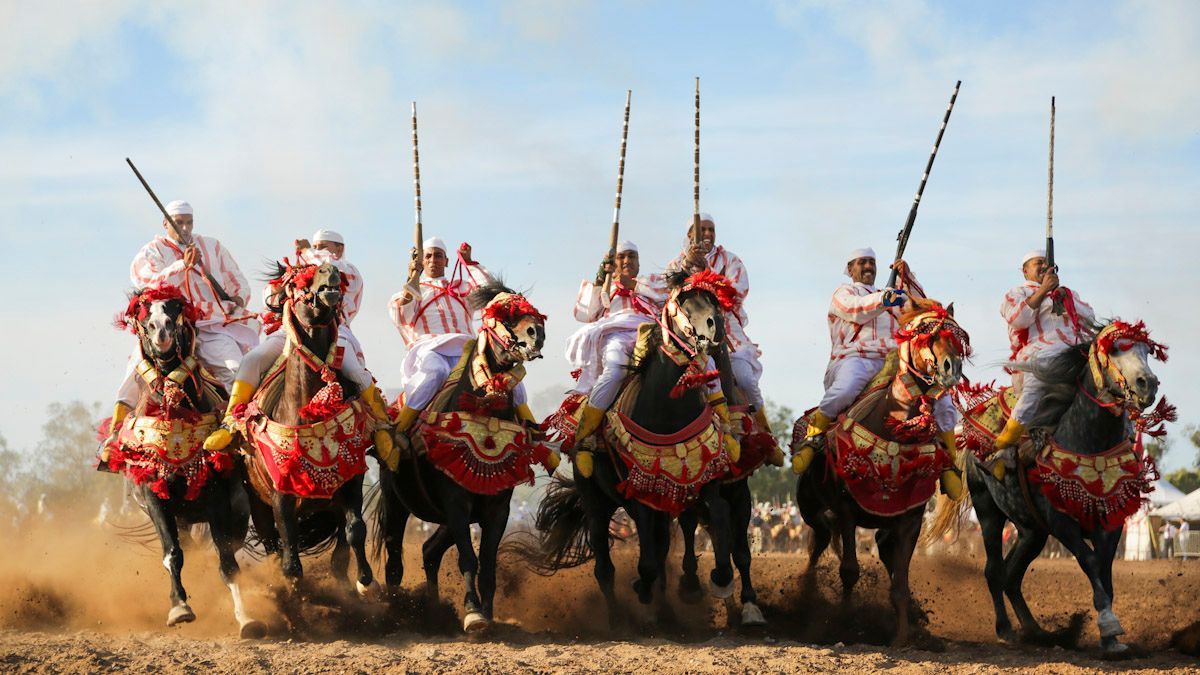 Colorful Moroccan festival with traditional costumes and music, perfect for cultural experiences.