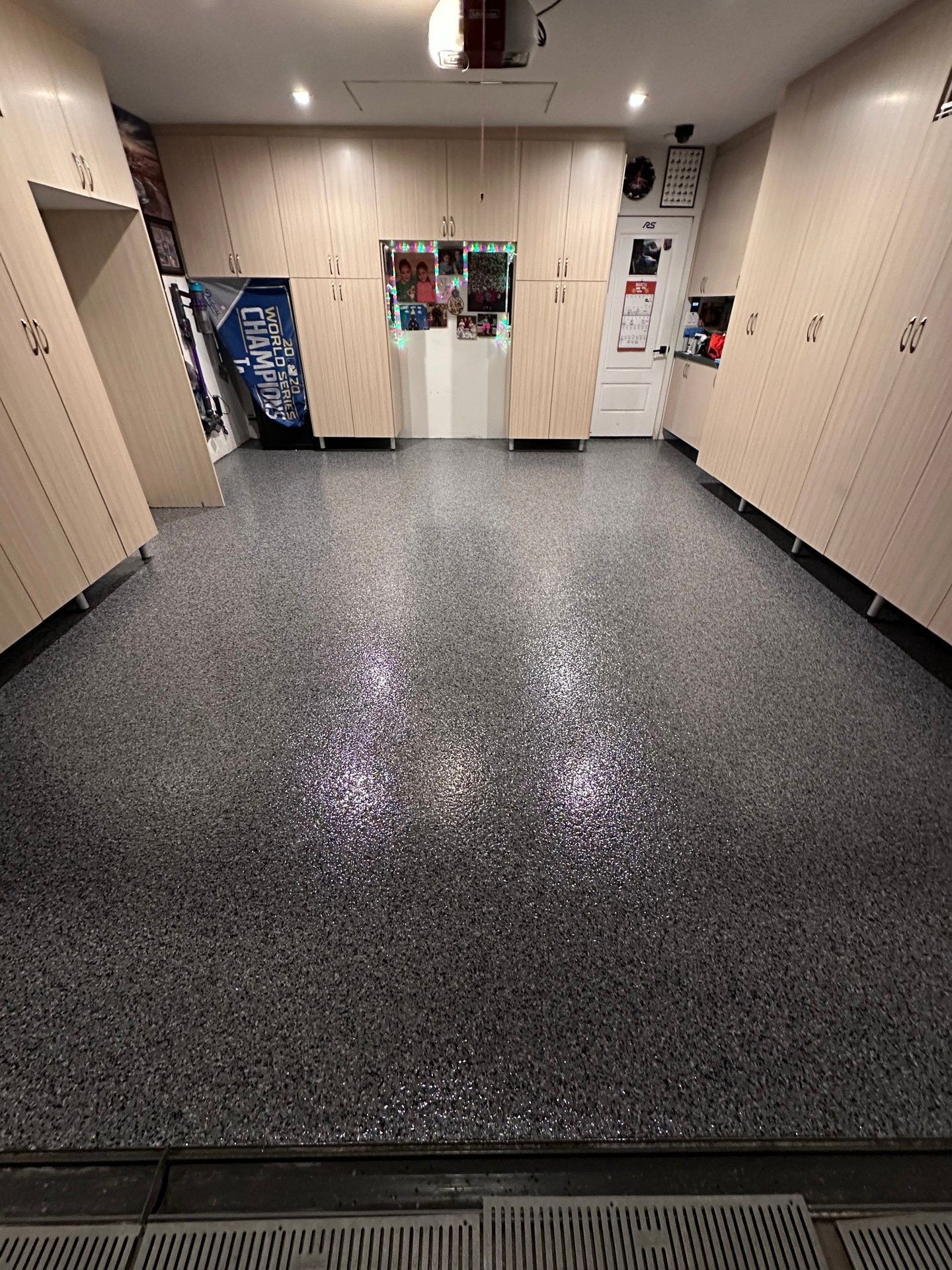 Garage with speckled gray epoxy floor, lockers, and overhead lighting.