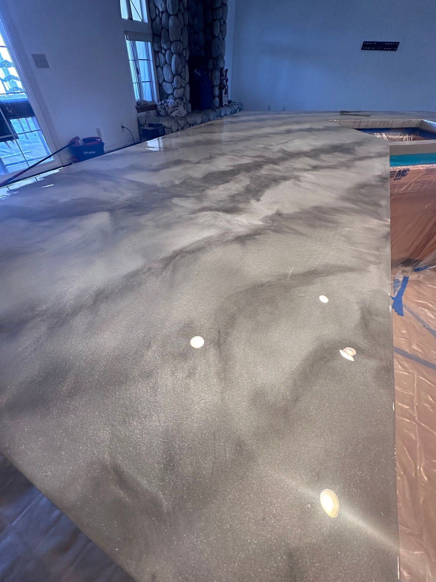 Metallic gray epoxy countertop, swirled design, indoor setting.
