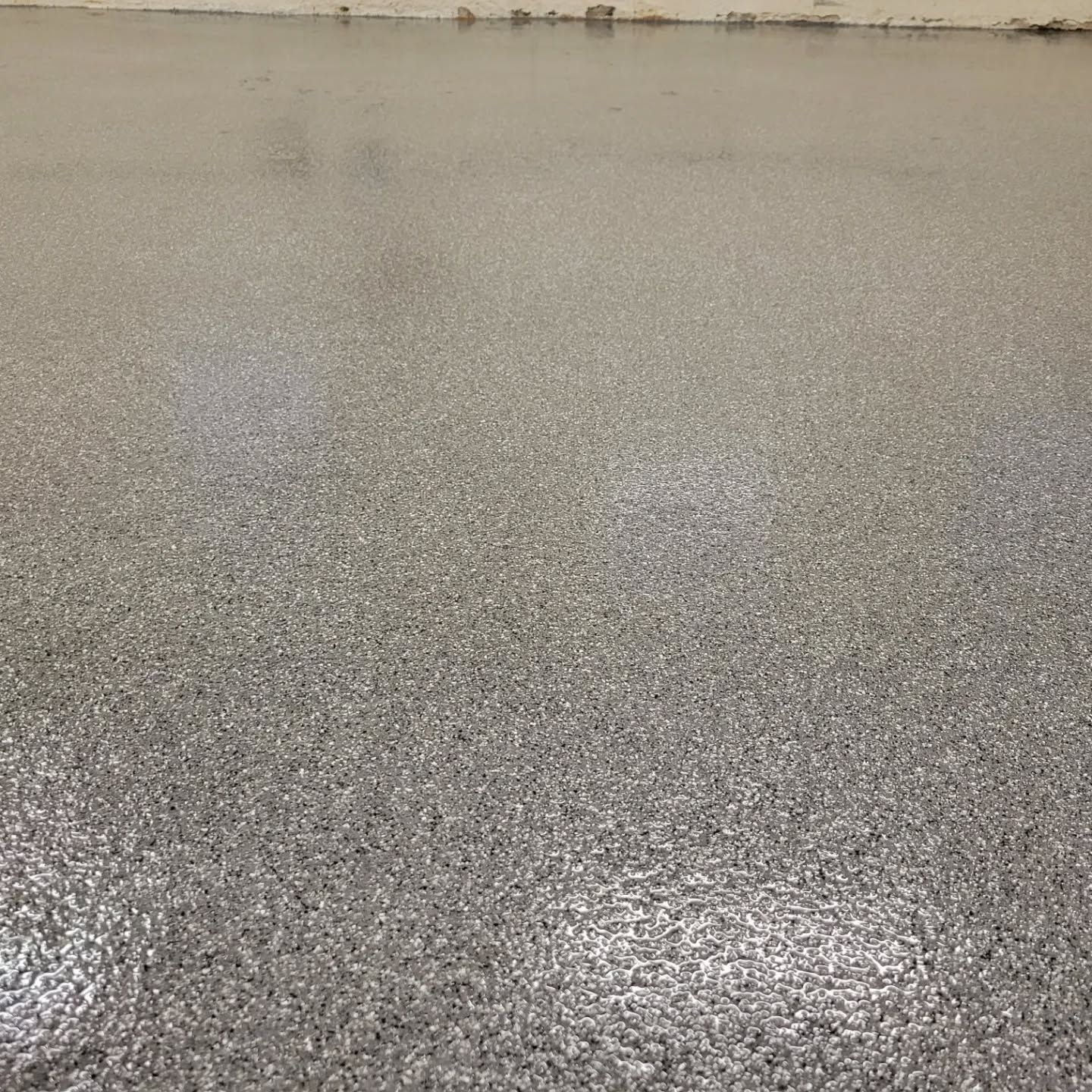 Gray epoxy floor with speckled texture.